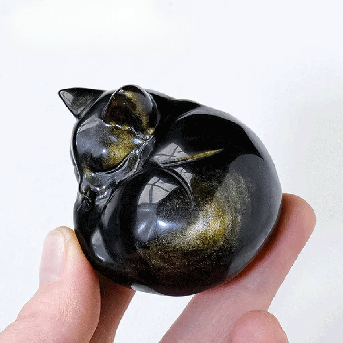 Golden obsidian carved sleeping cat figurine