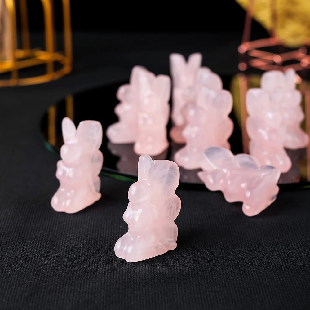 Hand-carved rose quartz angel figurine - front view, symbol of love and protection