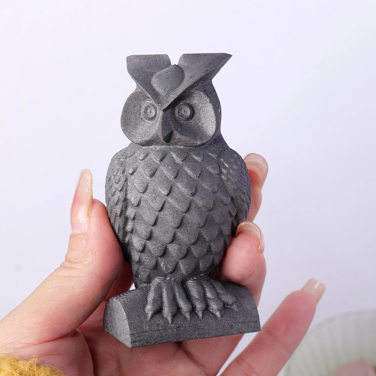 Carved owl from black shungite stone