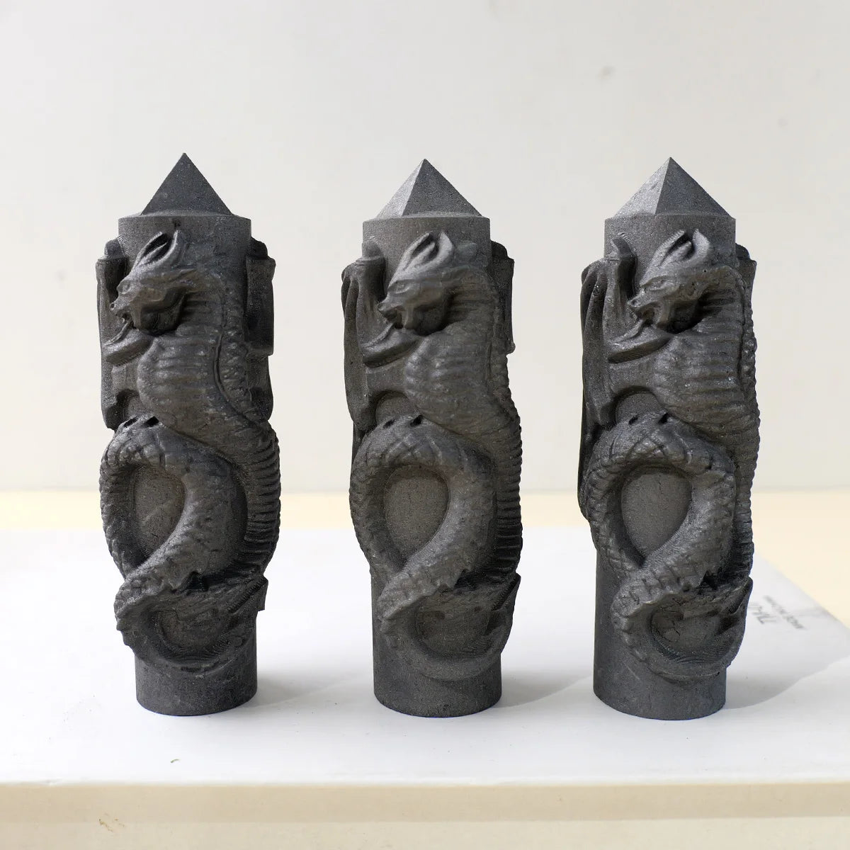 Mythical dragon wrapped around shungite pillar
